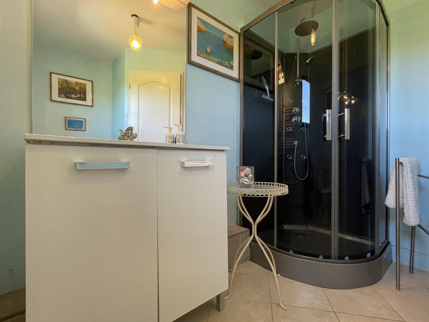 En-suite bathroom with curved shower cabin and vanity unit at Maison Lajus master bedroom, Pyrénées-Atlantiques