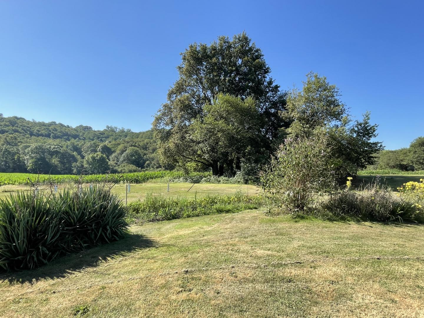Open countryside views across the vegetable garden and fields at Maison Lajus, Béarn, Pyrénées-Atlantiques